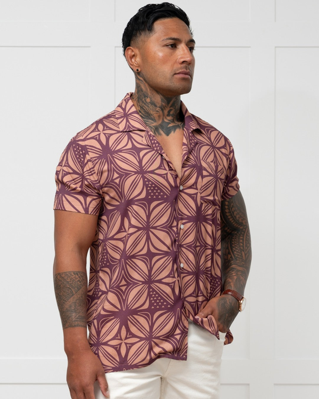 Man wearing a patterned island shirt with a white background